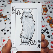 A drawing of a King of hearts playing card but the two heads of the king are actually heads of a penis